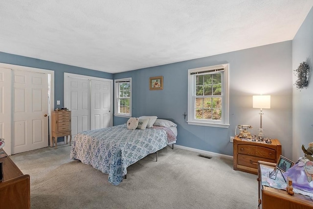 10 Oak Ridge Dr Unit 6, Maynard, MA 01754 - bedroom featuring multiple windows, light colored carpet, and baseboards