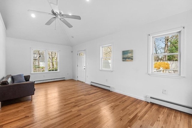 unfurnished room with a baseboard radiator, light wood-type flooring, plenty of natural light, vaulted ceiling, and recessed lighting