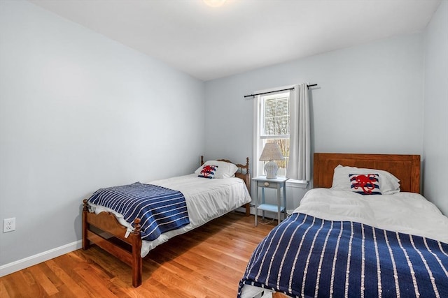 bedroom featuring wood finished floors and baseboards