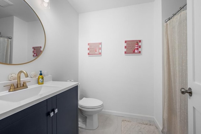 full bathroom featuring vanity, toilet, and baseboards