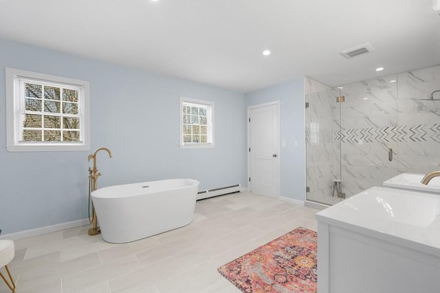 full bath featuring plenty of natural light, a baseboard heating unit, a marble finish shower, a freestanding bath, and recessed lighting