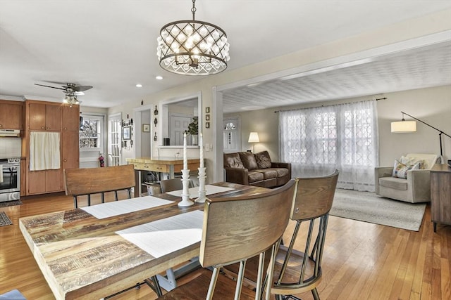 dining room featuring a notable chandelier and light wood-type flooring