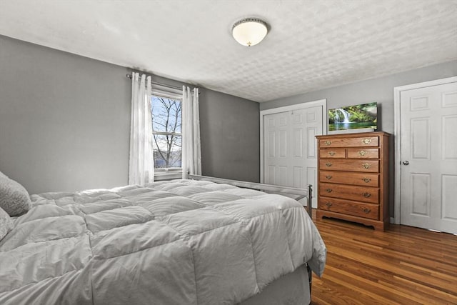 bedroom featuring dark hardwood / wood-style flooring and a closet