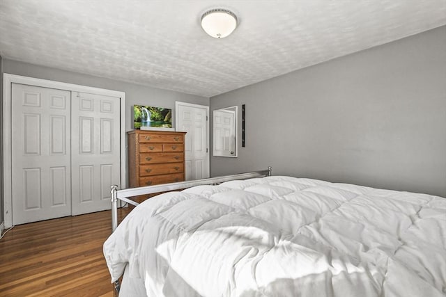 bedroom featuring hardwood / wood-style flooring and a textured ceiling