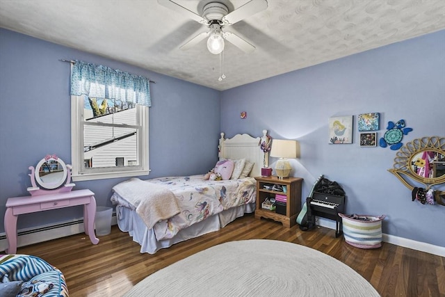 bedroom featuring dark hardwood / wood-style flooring, ceiling fan, and baseboard heating