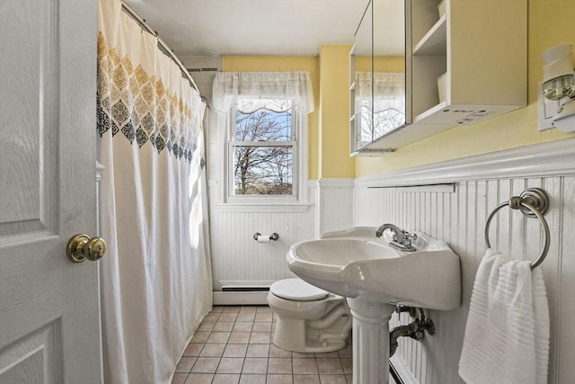 bathroom with a shower with curtain, toilet, tile patterned flooring, and a baseboard heating unit