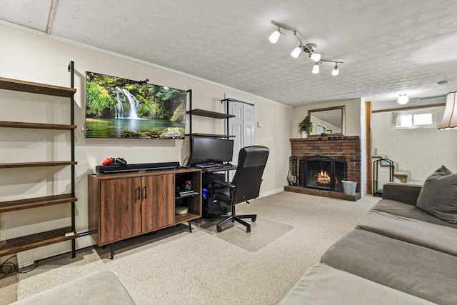 carpeted home office featuring a brick fireplace and a textured ceiling