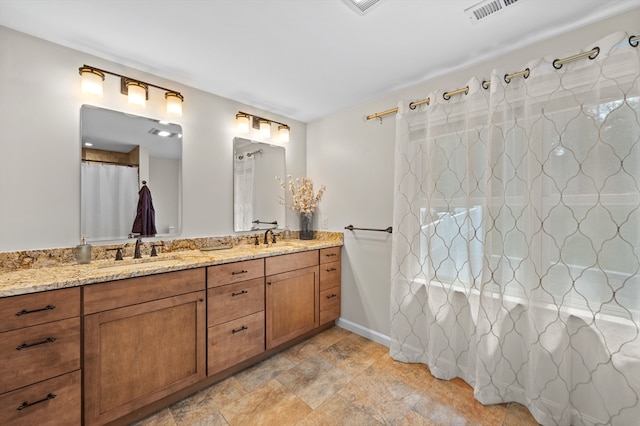 57 Hampton St, Auburn, MA 01501 - bathroom featuring double vanity, a shower with curtain, and stone finish flooring