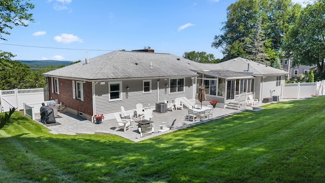 57 Hampton St, Auburn, MA 01501 - back of house featuring a sunroom, a patio, and a fenced backyard