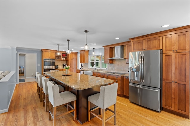 57 Hampton St, Auburn, MA 01501 - kitchen with appliances with stainless steel finishes, wall chimney range hood, open shelves, brown cabinets, and a center island