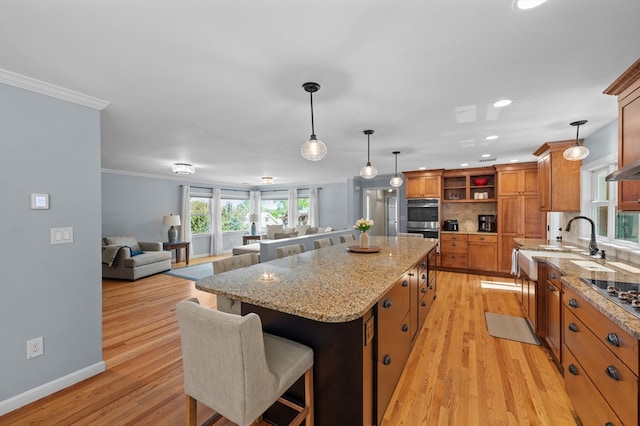 57 Hampton St, Auburn, MA 01501 - kitchen featuring open shelves, brown cabinetry, a center island, light wood finished floors, and crown molding