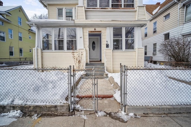 view of front of property with a fenced front yard and a gate