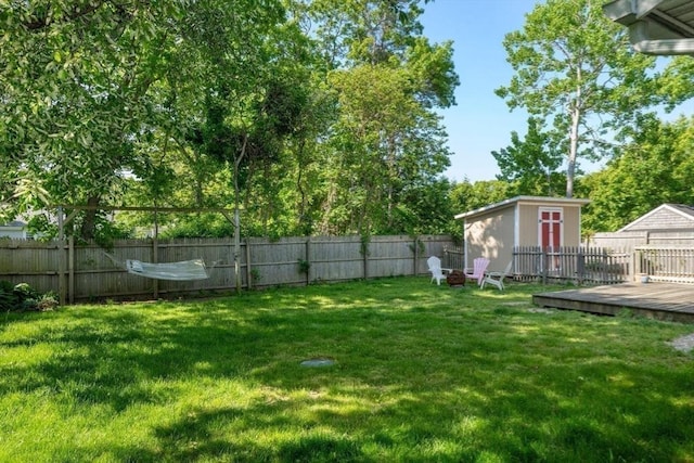 22 Janet St, Plymouth, MA 02360 - fenced backyard featuring a deck, a shed, and a fire pit