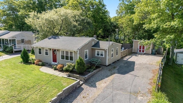 22 Janet St, Plymouth, MA 02360 - view of front of home featuring a shed, driveway, a chimney, and view of wooded area