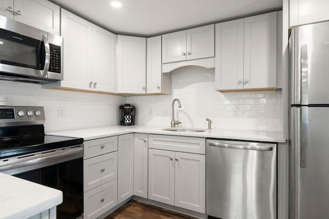 22 Janet St, Plymouth, MA 02360 - kitchen with stainless steel appliances, light countertops, decorative backsplash, dark wood finished floors, and white cabinets