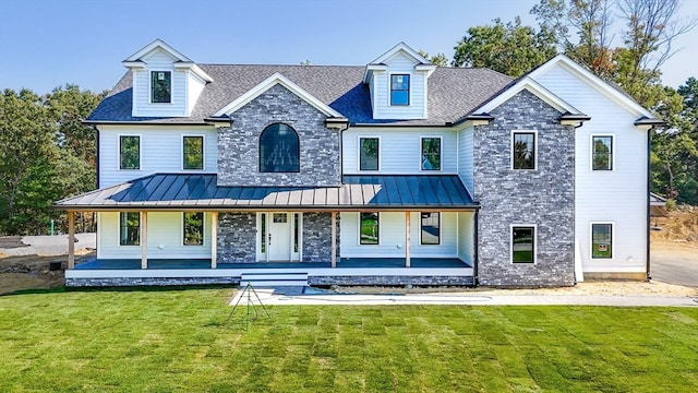 rear view of property with a porch and a yard