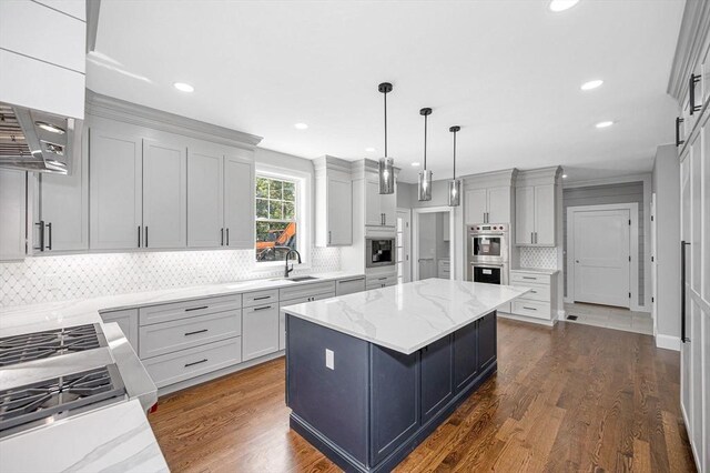 kitchen featuring light stone countertops, wall chimney range hood, and tasteful backsplash