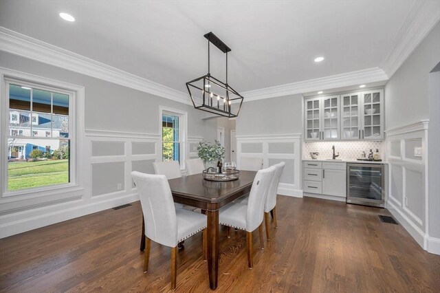 mudroom with light wood-type flooring, wooden walls, and sink