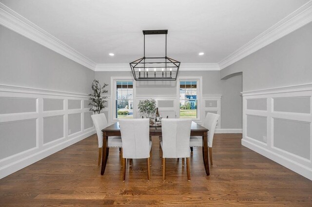 dining room with a notable chandelier, dark hardwood / wood-style floors, and ornamental molding