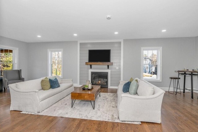 unfurnished living room featuring ornamental molding, dark hardwood / wood-style flooring, and a wealth of natural light