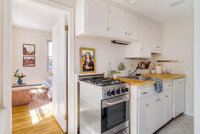 11 Revere Unit 4, Boston, MA 02114 - kitchen with stainless steel gas range, white cabinetry, light countertops, white dishwasher, and a sink