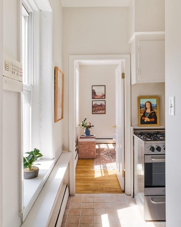 11 Revere Unit 4, Boston, MA 02114 - corridor with light tile patterned floors and baseboard heating