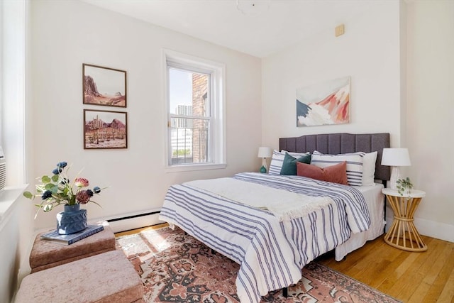 11 Revere Unit 4, Boston, MA 02114 - bedroom with wood finished floors, baseboard heating, and baseboards