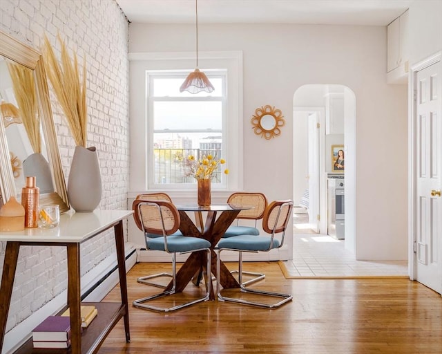 11 Revere Unit 4, Boston, MA 02114 - dining room featuring arched walkways, wood finished floors, and brick wall