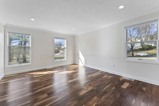 unfurnished room featuring crown molding, plenty of natural light, and visible vents