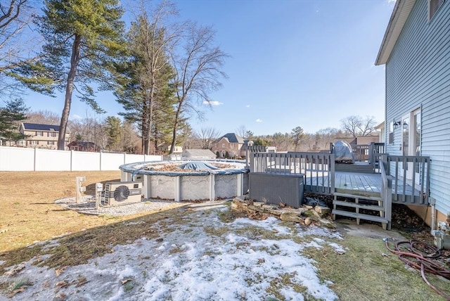 view of yard with ac unit, a wooden deck, a covered pool, and fence