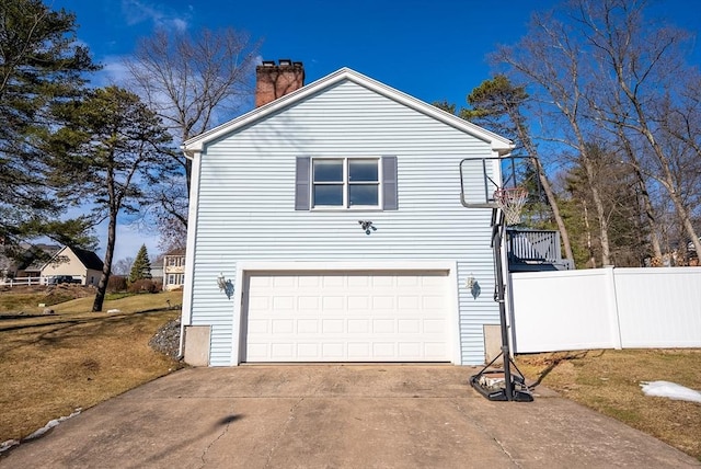 view of property exterior featuring driveway, an attached garage, a chimney, and fence