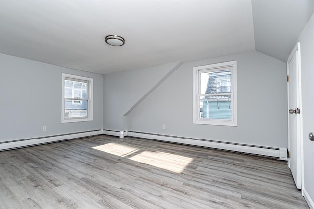 bonus room with lofted ceiling, wood finished floors, and a wealth of natural light