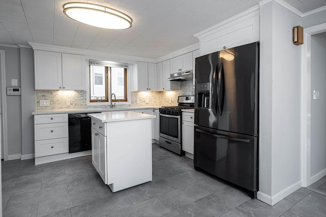 kitchen with crown molding, light countertops, a sink, and black appliances