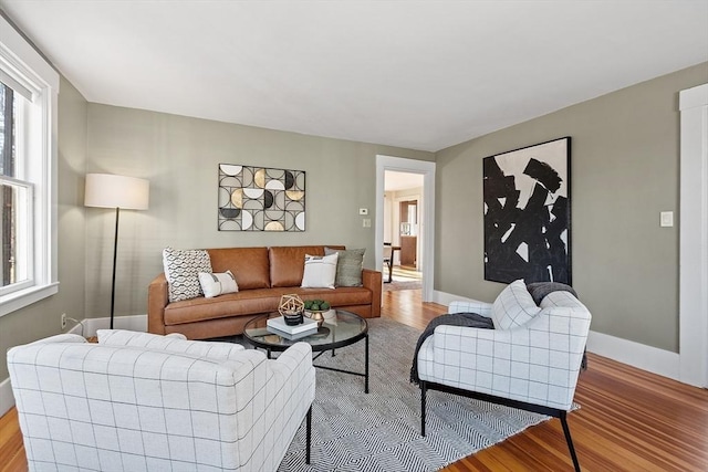 living area with baseboards and light wood-style flooring