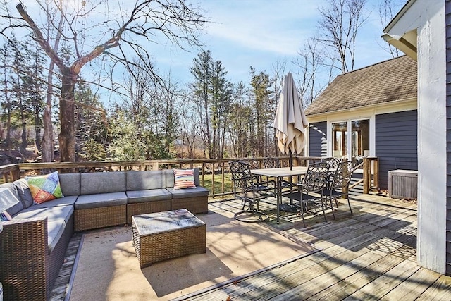 wooden terrace with outdoor dining area and outdoor lounge area