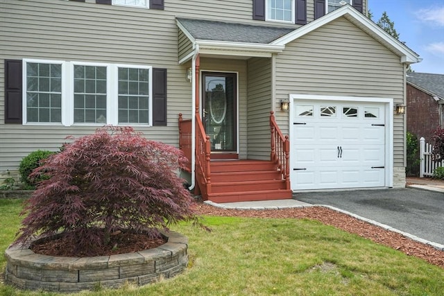 82 Lloyd Ave, Springfield, MA 01119 - view of exterior entry featuring asphalt driveway, roof with shingles, and a lawn