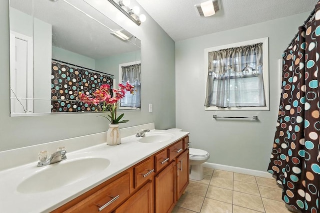 82 Lloyd Ave, Springfield, MA 01119 - bathroom featuring double vanity, tile patterned flooring, plenty of natural light, and curtained shower