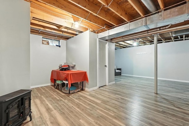 82 Lloyd Ave, Springfield, MA 01119 - below grade area with a wood stove and wood finished floors