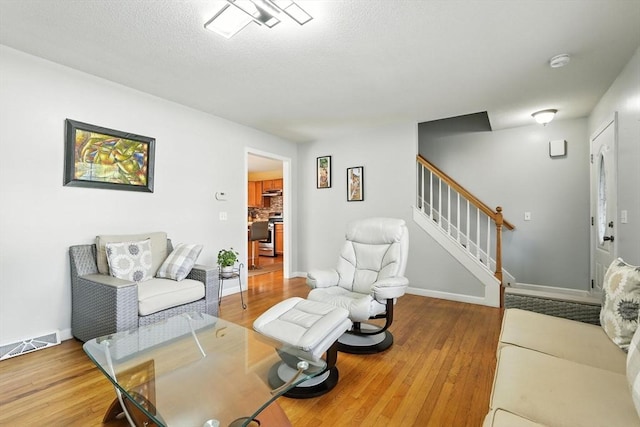 82 Lloyd Ave, Springfield, MA 01119 - living area with wood finished floors and stairway
