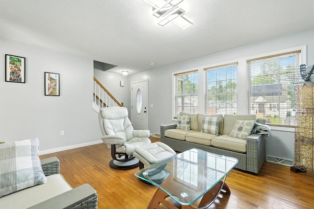 82 Lloyd Ave, Springfield, MA 01119 - living area featuring plenty of natural light, wood finished floors, stairway, and a textured ceiling
