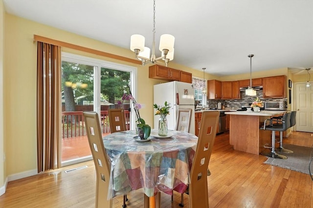 82 Lloyd Ave, Springfield, MA 01119 - dining area featuring light wood-style flooring and a chandelier
