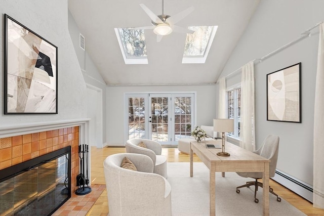 office with a baseboard radiator, a fireplace, visible vents, and light wood-style flooring