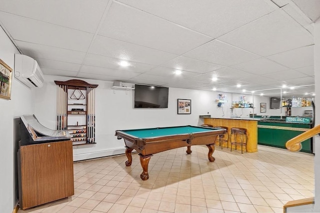 playroom with a drop ceiling, a wall unit AC, bar area, baseboards, and a wall mounted AC