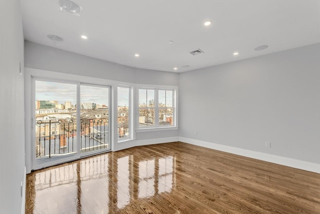 unfurnished room with wood-type flooring