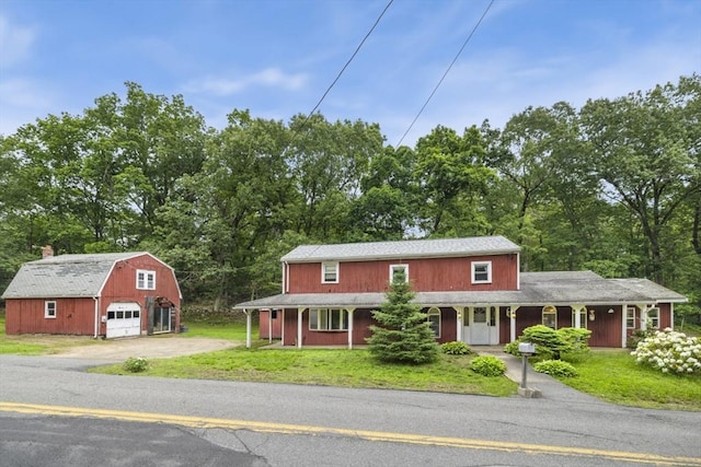 121 Liberty St, Middleton, MA 01949 - view of front of property with a garage, an outdoor structure, a porch, and a front lawn