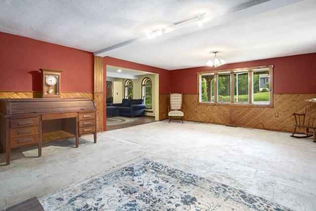 121 Liberty St, Middleton, MA 01949 - living room featuring wainscoting, wooden walls, and a chandelier
