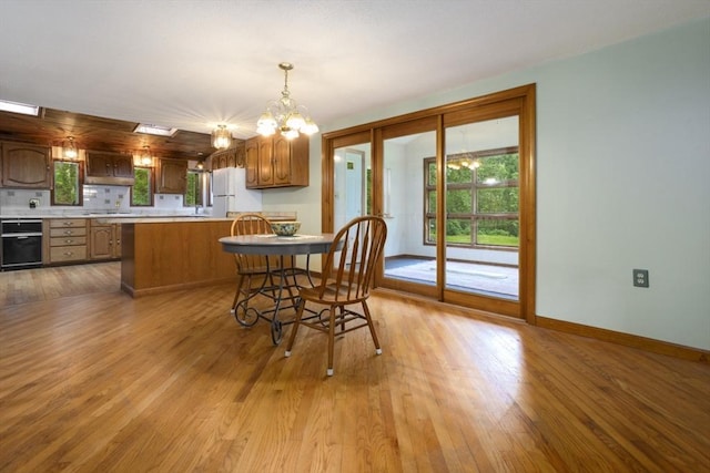 121 Liberty St, Middleton, MA 01949 - dining space with a chandelier and light wood finished floors
