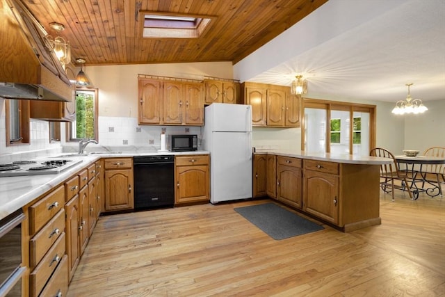 121 Liberty St, Middleton, MA 01949 - kitchen featuring black appliances, a peninsula, light countertops, backsplash, and light wood finished floors