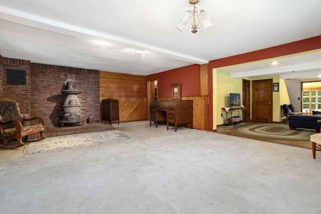121 Liberty St, Middleton, MA 01949 - living area featuring a wood stove, wooden walls, and beamed ceiling
