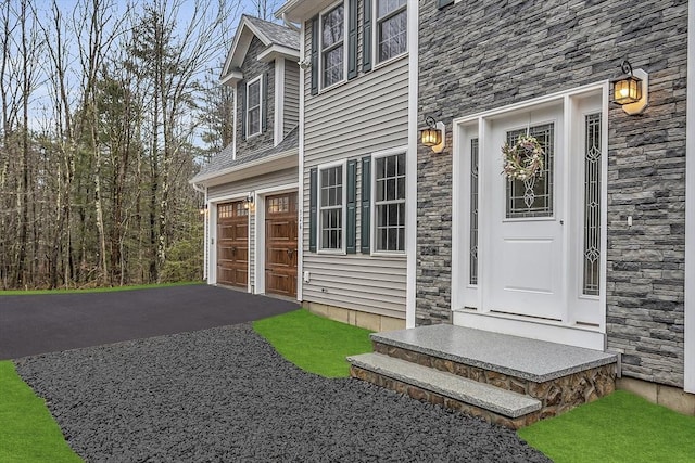 62 Bolton Rd Applewood, Unit Applewood, Westminster, MA 01473 - doorway to property with stone siding, driveway, and a garage